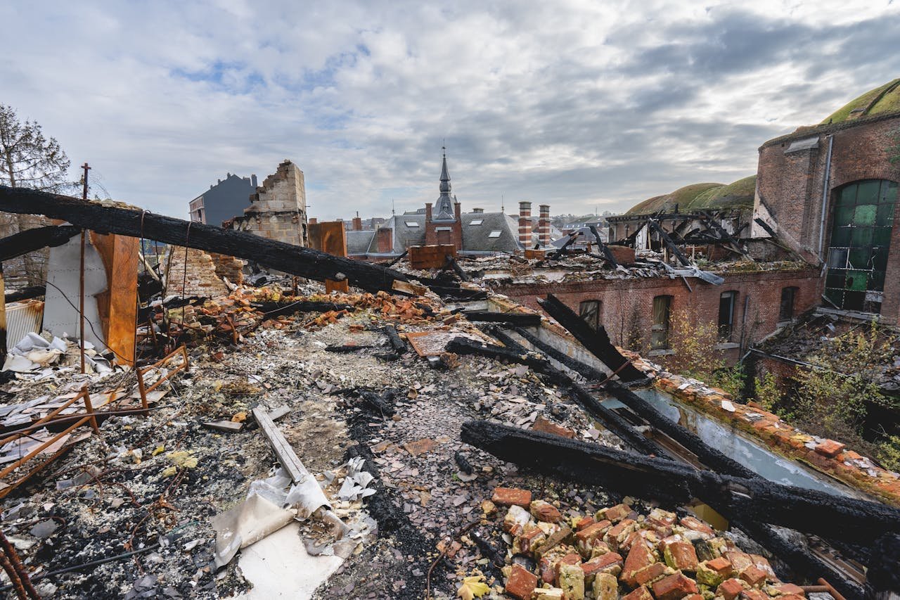 A panoramic view of an abandoned and decayed urban landscape showing broken buildings and debris.