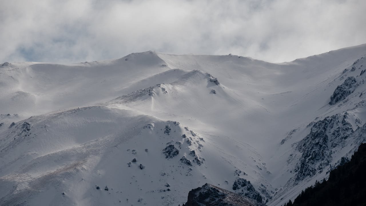 Breathtaking view of snow-covered mountains in Esquel, Argentina, showcasing winter's beauty.