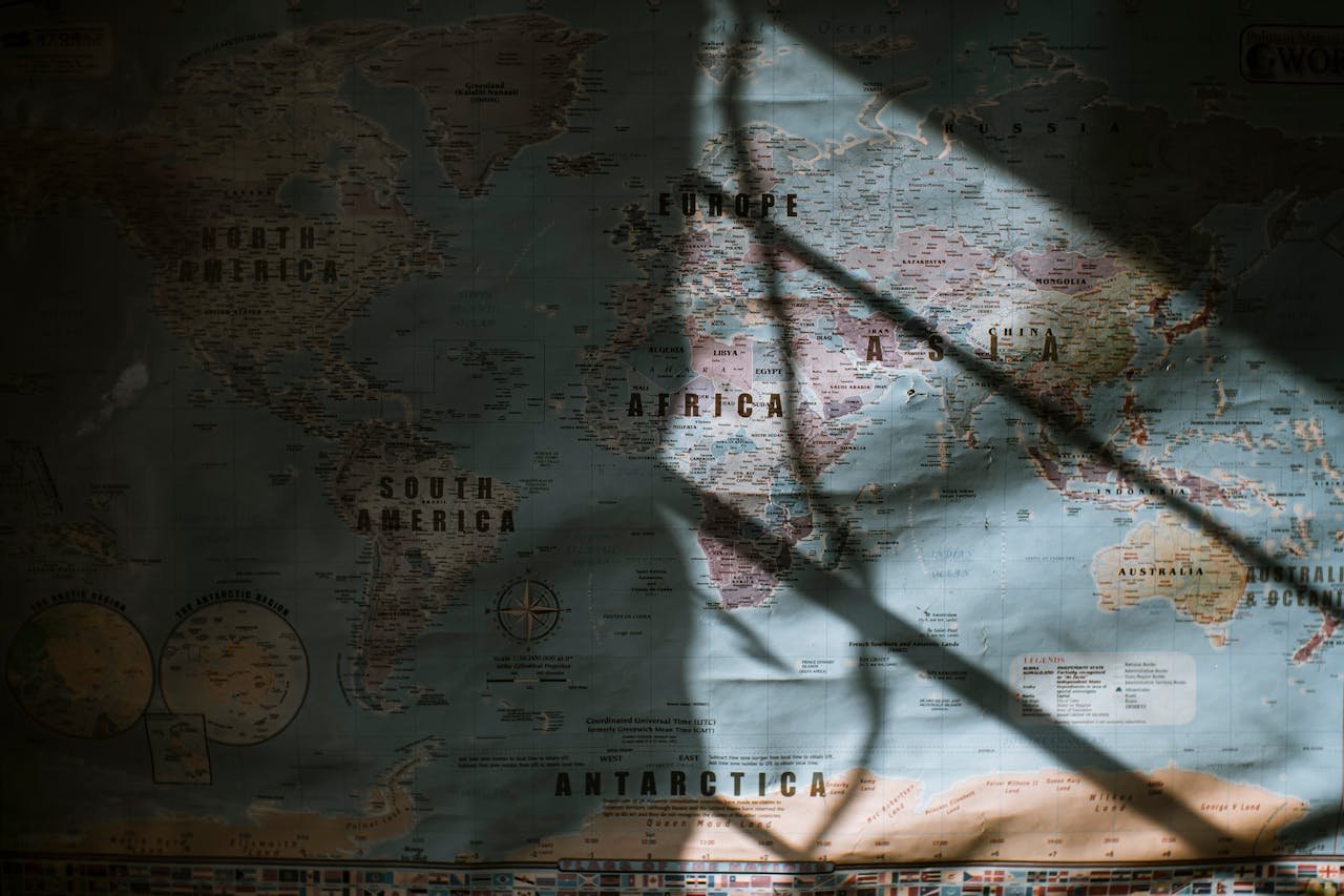 Map of the world with sunlight casting dramatic shadows across its surface.